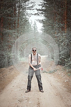 Cannibal steampunk Man in glasses with ax in forest