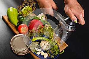 Canning vegetables. Hands with canning key. Herbs and vegetables for preservation