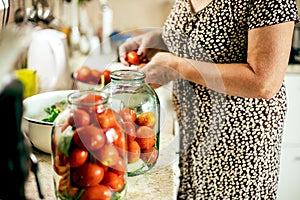 Canning vegetables tomatoes. Woman pickled preserving tomatoes herbs for canning pickling
