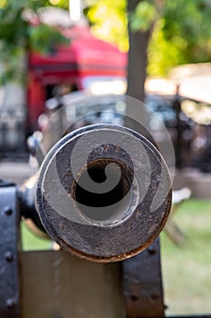 Cannon barrel with round hole close-up, traditional fort guard weapon photo