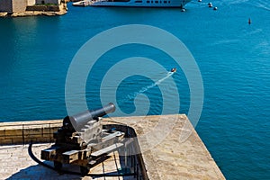 A cannon firing at a boat. Humour concept. Valletta Malta