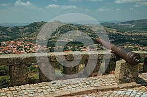 Cannon overlooking hilly landscape in Monsanto