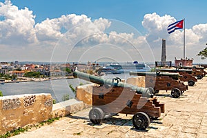 Cannons at Fort of Saint Charles, cuban flag and cruise ship in Havana