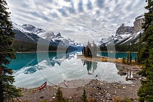 Canoe anchored with canadian rockies reflection on Maligne lake at Spirit island in Jasper national park