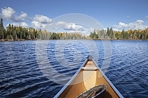 Canoe on a blue lake in northern Minnesota during autumn