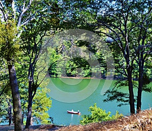 CANOE ON AN EMERALD GREEN LAKE