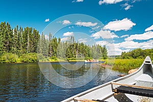 Canoe floating on Lake in a forest of Canada