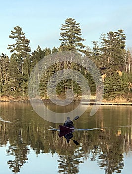 A canoe on Glass like view of the water of Lake of the Woods