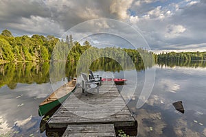 Canoe and Kayak tied to a dock on a lake in Ontario Canada