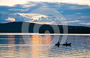 Canoe on lake at sunset