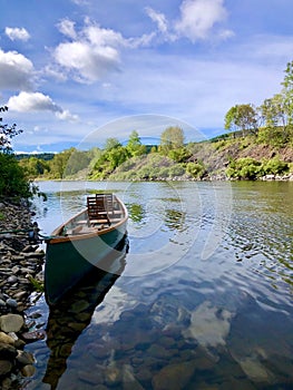 Canoe moored on riverbank