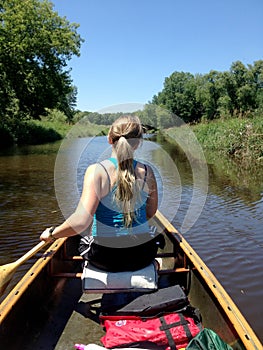 Canoe paddling on small stream