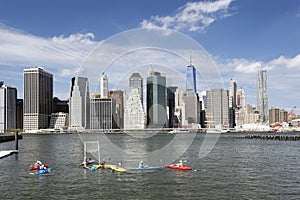 canoe polo in east river new york city with lower manhattan skyline in the background