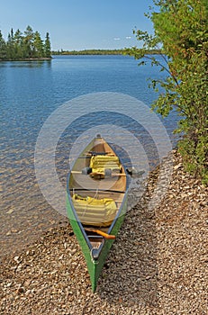 Canoe Ready on a Calm Lakeshore photo