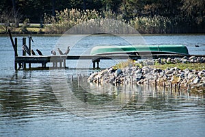 Canoe resting on dock by lake