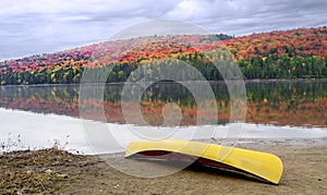 Canoe on shore with Autumn Colours