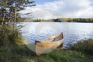 Canoe on the shore of a northern Minnesota lake during autumn