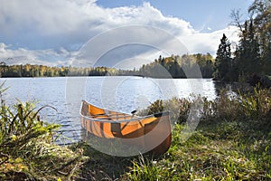 Canoe on the shore of a northern Minnesota lake during autumn