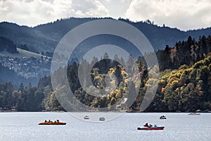 Canoe and speedboat on lake