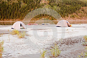 Canoe tent camp at Yukon River in taiga wilderness