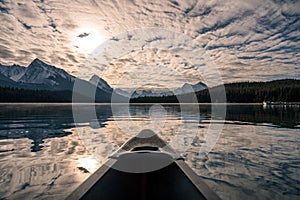 Canoeing with Canadian Rockies and sunlight cloudy on Maligne lake at Jasper national park