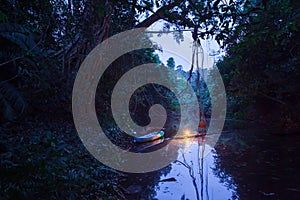 Canoeing in a dark rainforest