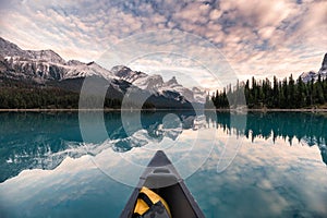 Canoeing on Maligne lake with canadian rockies reflection in Spirit Island at Jasper national park