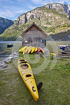 Canoeing in Norway. Fjord landscape with wooden cabin. Recreation