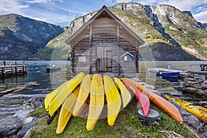 Canoeing in Norway. Fjord landscape with wooden cabin. Recreation