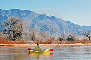 Canoeist on scenic lake