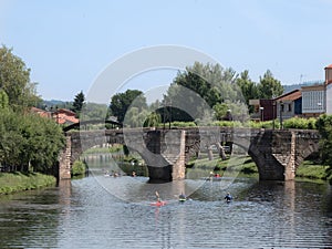 Canoeists enjoying the river Cabe, as it passes through the city of Monforte de Lemos