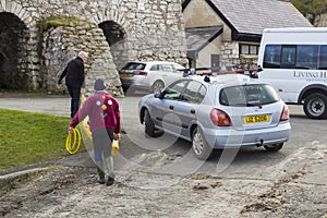 Canoeists unloading a canoe from a car roof rack in Ballintoy Northern Ireland