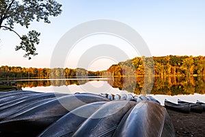 Canoes await their paddlers at Sand Lake on an autumn morning.