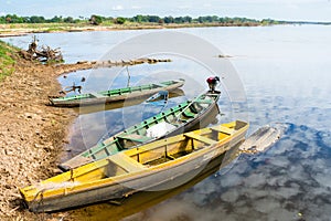 Canoes docked at the river`s edge photo