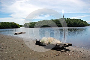 Canoes with fishing net at beach Papua New Guinea