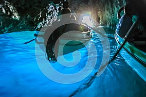 Canoes Inside turquoise grotto, Capri blue cave, Italy