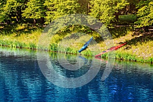 Canoes and kayaks on the shore a river