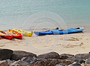 Canoes in many colors on the beach