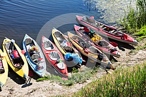 Canoes on a river-bank.