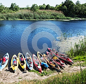 Canoes on a river-bank.