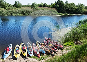 Canoes on a river-bank.