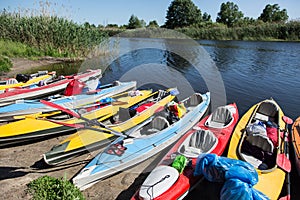 Canoes on a river-bank.