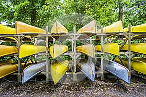 Canoes scene on wooden racks at the Berge des Baigneurs park in Laval