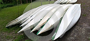 Canoes on the shore waiting for children in the summer camp