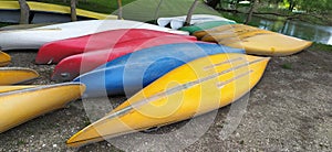 Canoes on the shore waiting for children in the summer camp