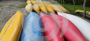 Canoes on the shore waiting for children in the summer camp