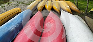 Canoes on the shore waiting for children in the summer camp