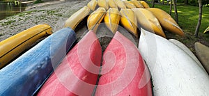 Canoes on the shore waiting for children in the summer camp