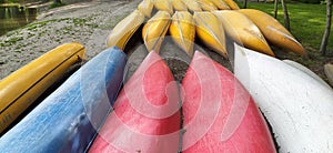 Canoes on the shore waiting for children in the summer camp