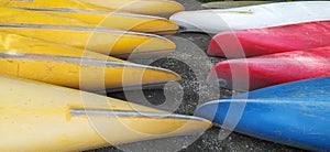 Canoes on the shore waiting for children in the summer camp